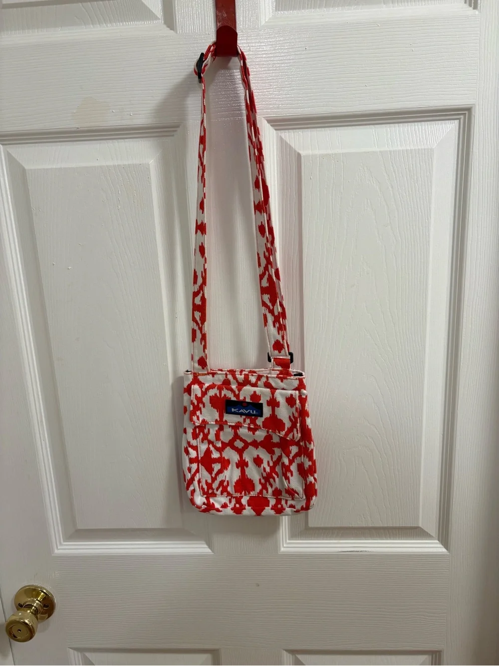 KAVU small cross body bag, orange and white pattern, snap top closure